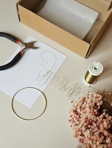 Craft supplies including wire, flowers, and tools.