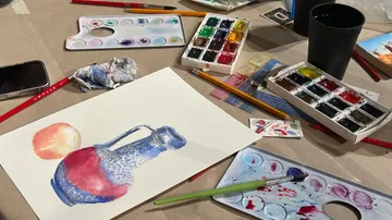 Watercolor painting of pitcher and fruit on table.
