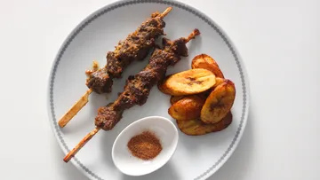 Skewers with plantains and spice on plate.