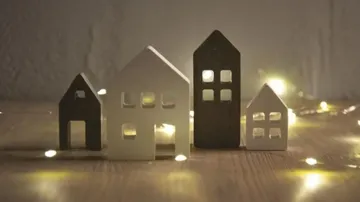 Small decorative houses with lights on wood.
