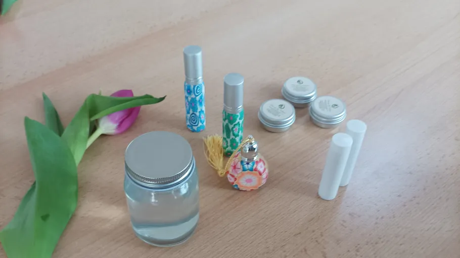 Kosmetikbehälter auf Holztisch mit Blume.