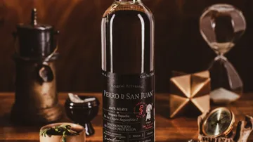 Bottle of mezcal surrounded by vintage items.