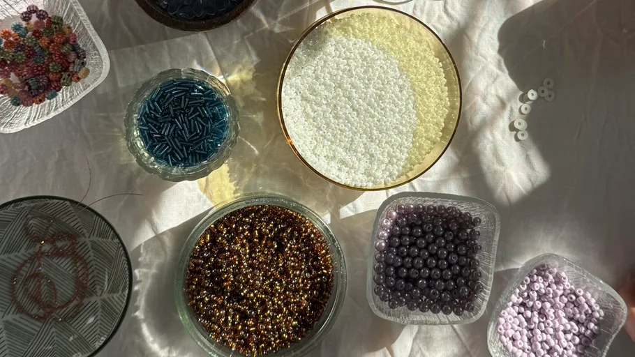 Assorted beads arranged on a white surface.