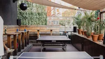 Ping pong table in an outdoor seating area.