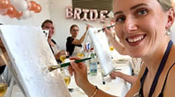 Women painting at bridal shower event.