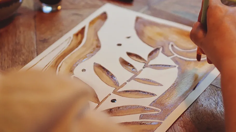 Hand painting leaf design on paper.