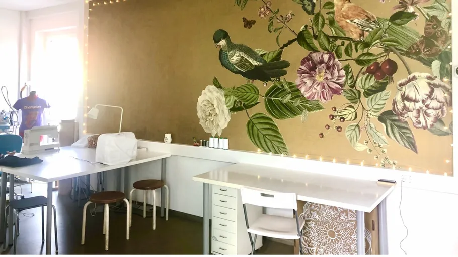 Sewing room with large floral wall mural.
