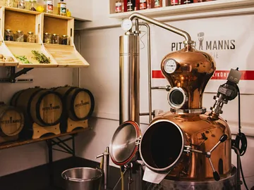Copper still processes ingredients in a small distillery.
