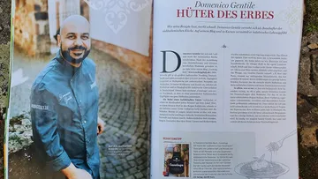 Chef in blue uniform standing, article text beside.