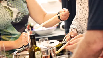 People preparing food in a kitchen setting.