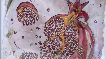 Colorful pomegranate split open, seeds scattered.