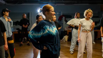 People dancing in a studio, smiling.