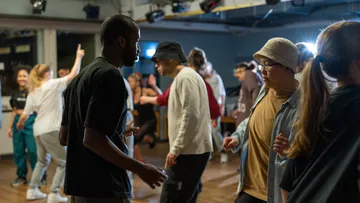 People dancing in a dimly lit room.