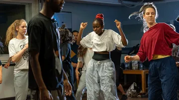 Group of people dancing in a room.