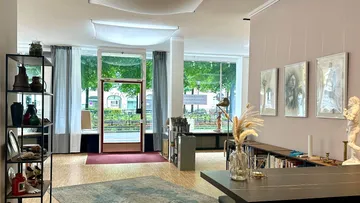 Art gallery interior with paintings and sculptures.