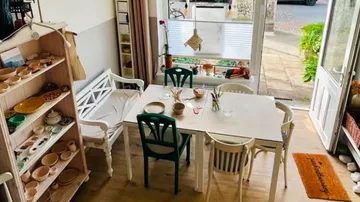 Table with chairs in cozy cafe setting.
