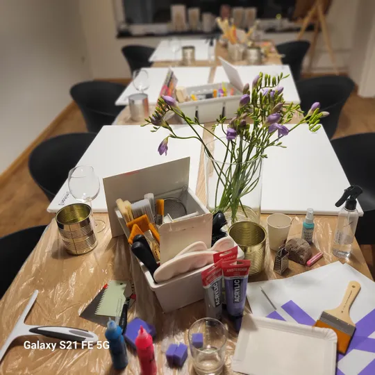 Art supplies on table in creative studio.