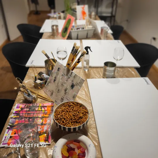 Art supplies on table in paint studio.