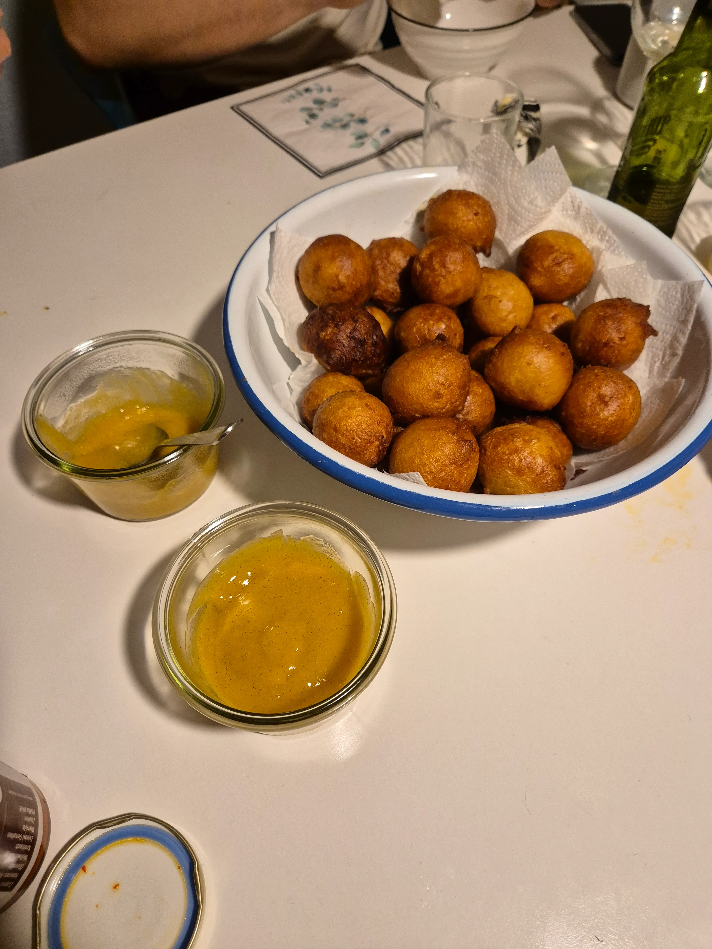 Fried balls and sauces on a table.