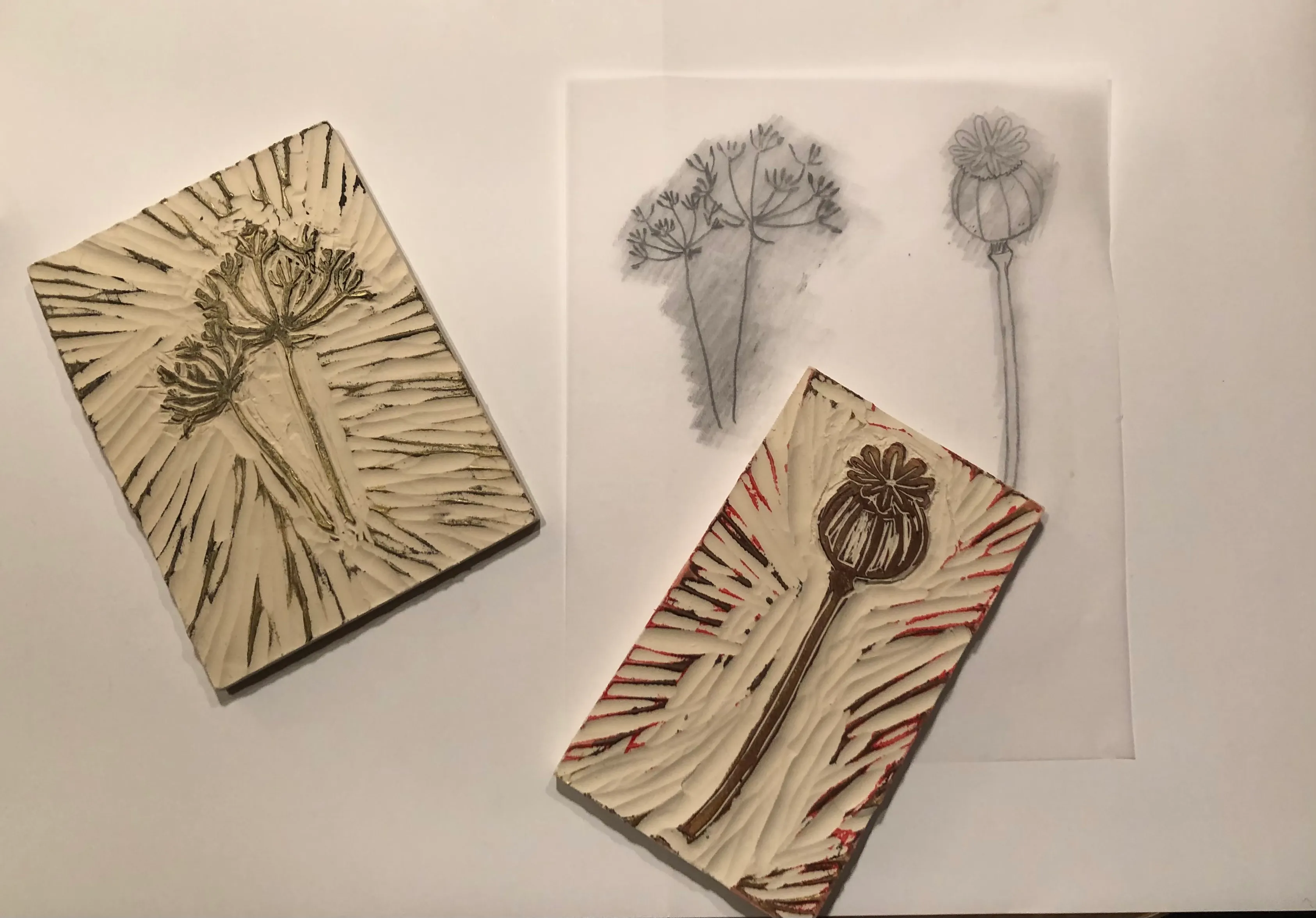 Two carved stamps and sketches on paper.