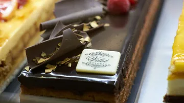 Chocolate cake slice with decorative toppings.