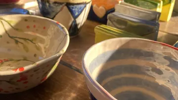 Colorful ceramic bowls on a wooden table.