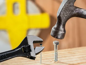 Pliers hold the screw, hammer hits a nail.