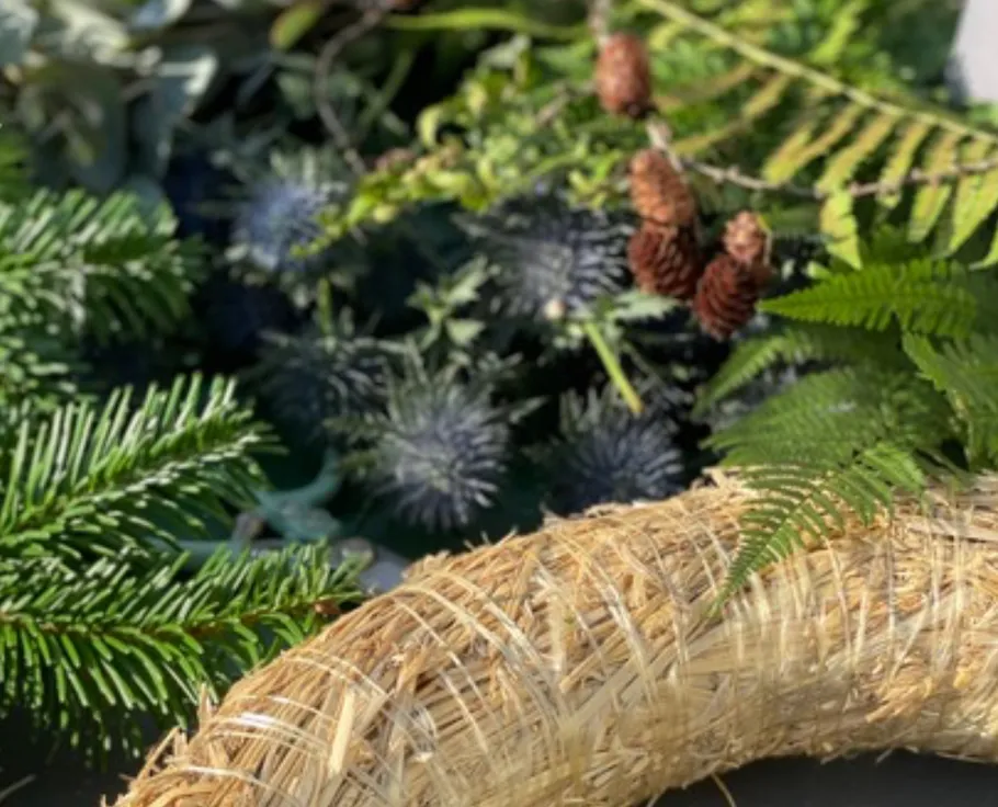 Wreath with pine cones and green foliage.