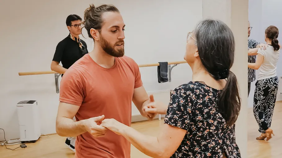 Two people dancing in a studio.