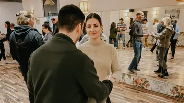 People dancing in a mirrored dance studio.