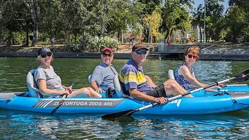 Four people kayaking on a lake.