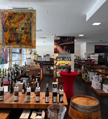 Wine shop interior with wooden shelves and bottles.