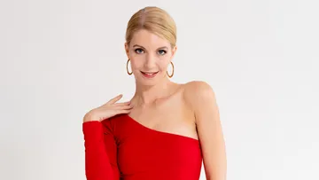 Person in red dress posing confidently, white background.