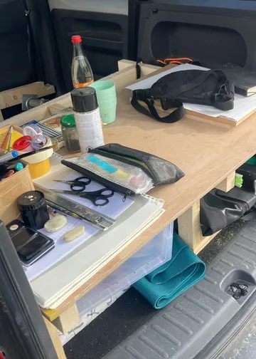 Supplies on a wooden board inside vehicle.