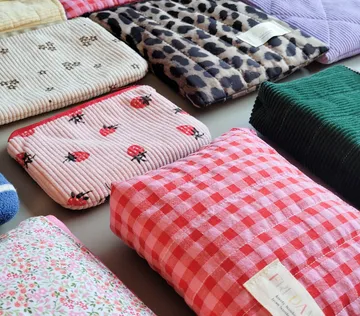 Colorful fabric pouches on a table.
