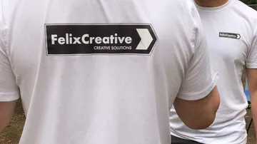 People wearing FelixCreative branded shirts outdoors.