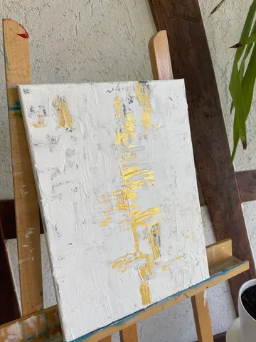 Abstract painting on easel with textured brushstrokes.
