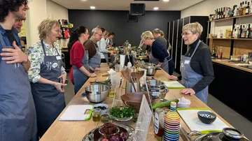 People cooking in a bright kitchen.