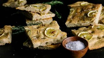 Focaccia bread with lemon and rosemary pieces.