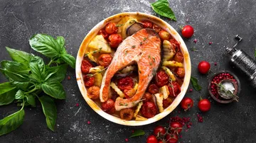 Salmon with roasted vegetables on a plate.