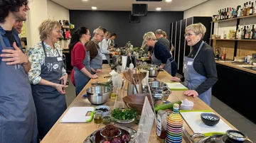 People cooking together in a kitchen.