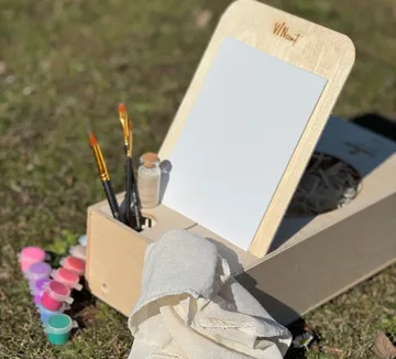 Painting kit with brushes on grass.