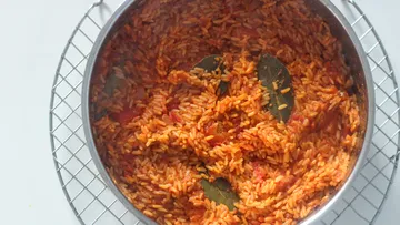 Cooked rice with bay leaves in pot.