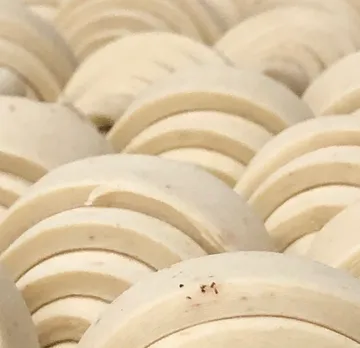 Close-up of stacked circular wooden shapes.