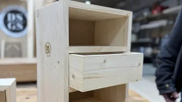 Wooden shelf with pull-out drawer in workshop.