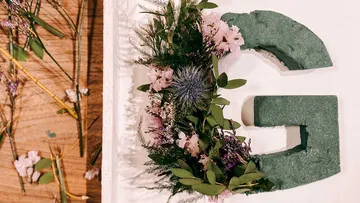 Floral arrangement on green letter G.