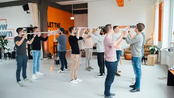 Group balancing rods in a bright room.