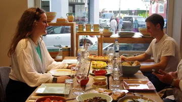 People dining at a table inside a restaurant.