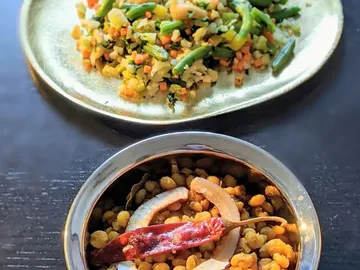 Bowl with lentils, pickled vegetables and red chili peppers.