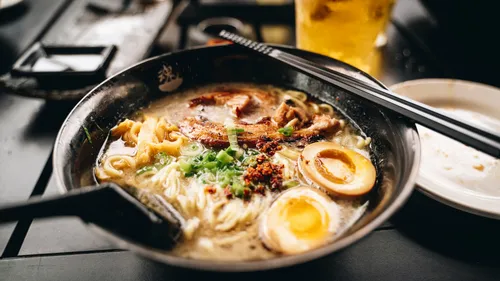 Bowl of ramen with egg and meat.